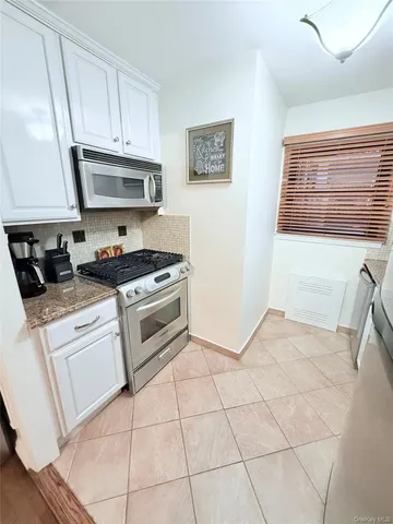 a kitchen with a stove a sink and a refrigerator