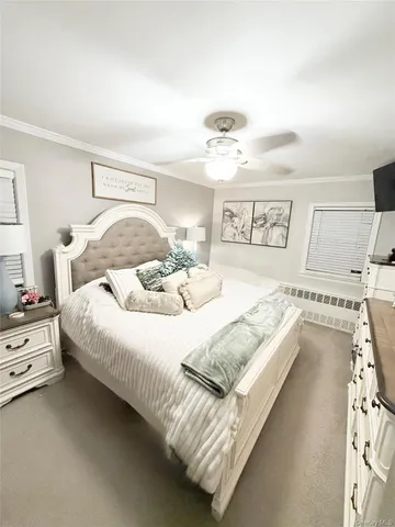 a bedroom with a bed and a large mirror