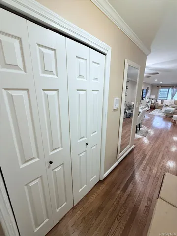 a view of a hallway with wooden floor