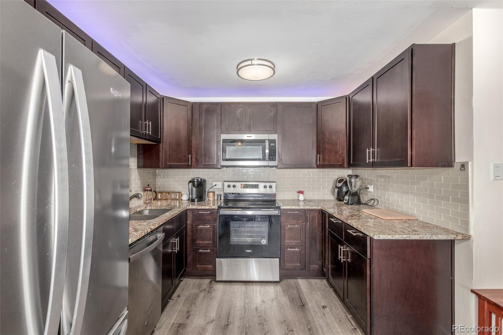 725 South Clinton Street, Unit 7B Denver, CO 80247 - Photo 15 of 29 a kitchen with a sink stove and refrigerator