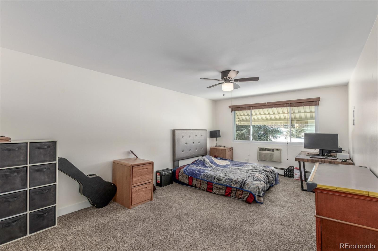 725 South Clinton Street, Unit 7B Denver, CO 80247 - Photo 17 of 29 a bedroom with furniture and a window
