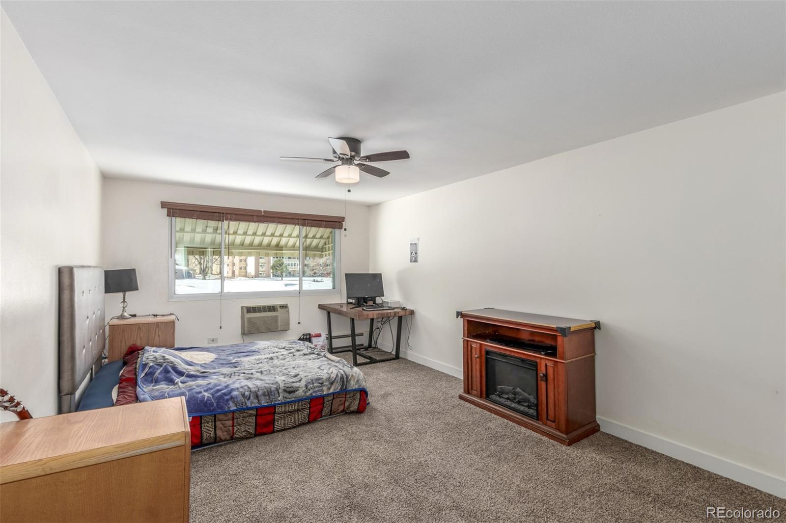 725 South Clinton Street, Unit 7B Denver, CO 80247 - Photo 18 of 29 a bedroom with a bed and a window