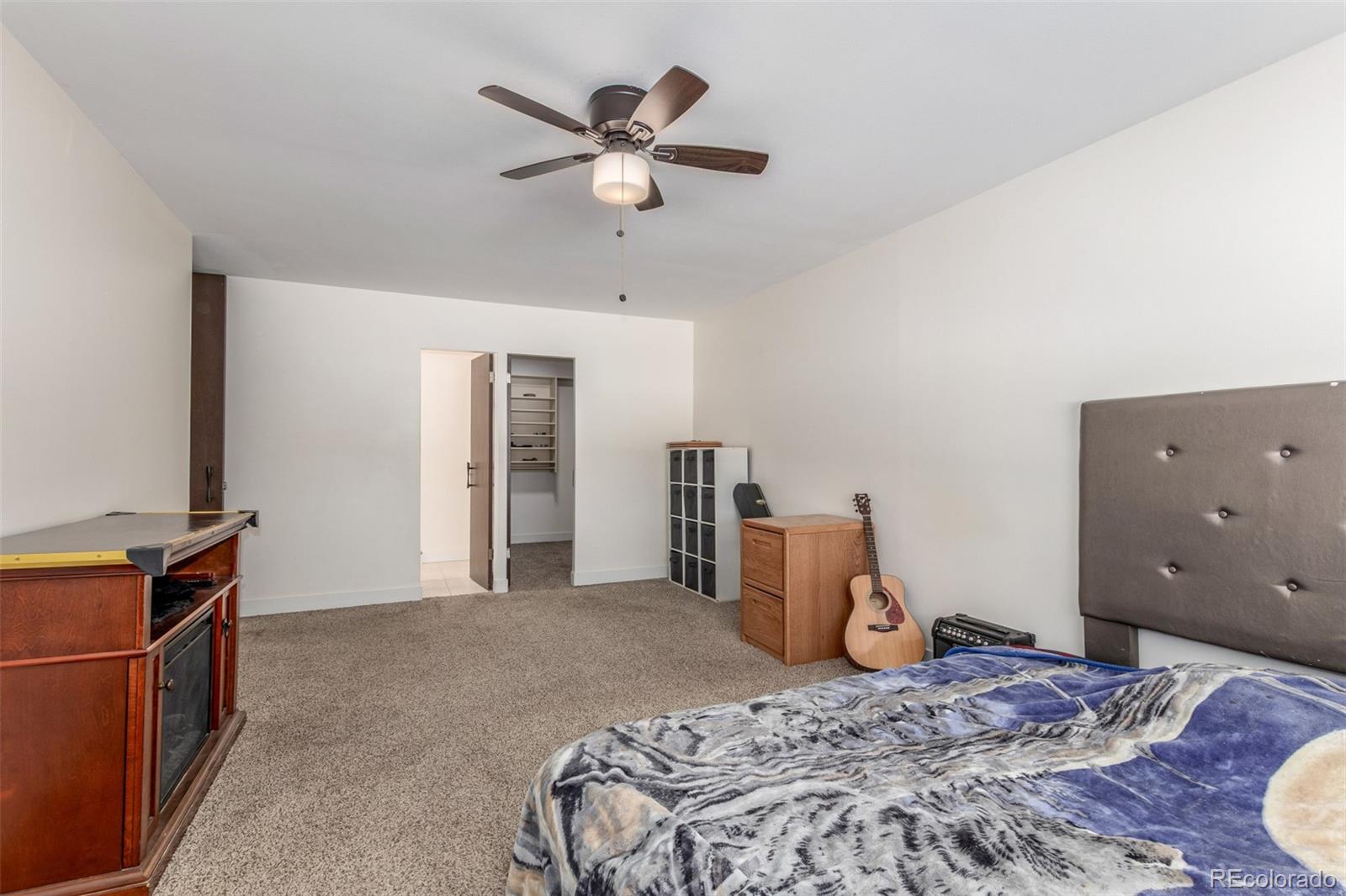 725 South Clinton Street, Unit 7B Denver, CO 80247 - Photo 19 of 29 a bedroom with a large bed and a chandelier