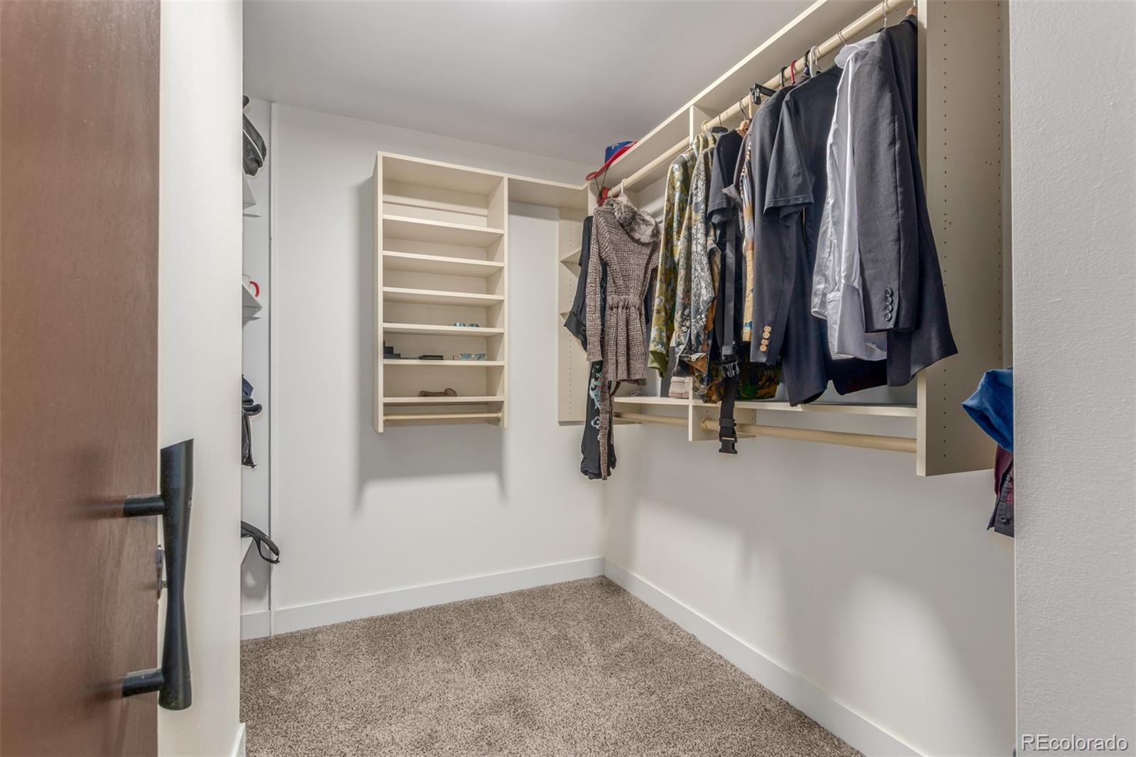 725 South Clinton Street, Unit 7B Denver, CO 80247 - Photo 22 of 29 a view of walk in closet with clothes