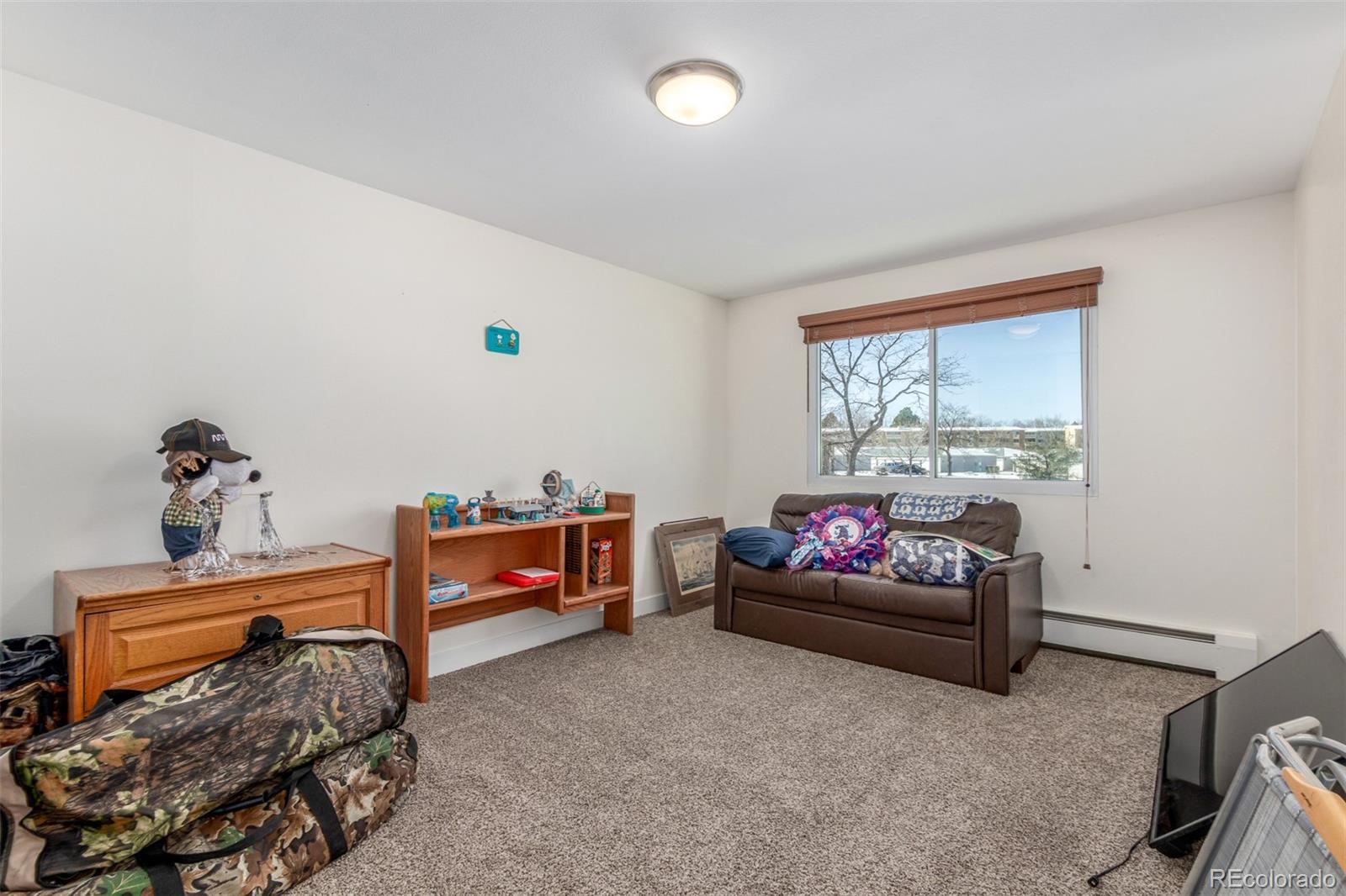 725 South Clinton Street, Unit 7B Denver, CO 80247 - Photo 23 of 29 a bedroom with furniture and a window