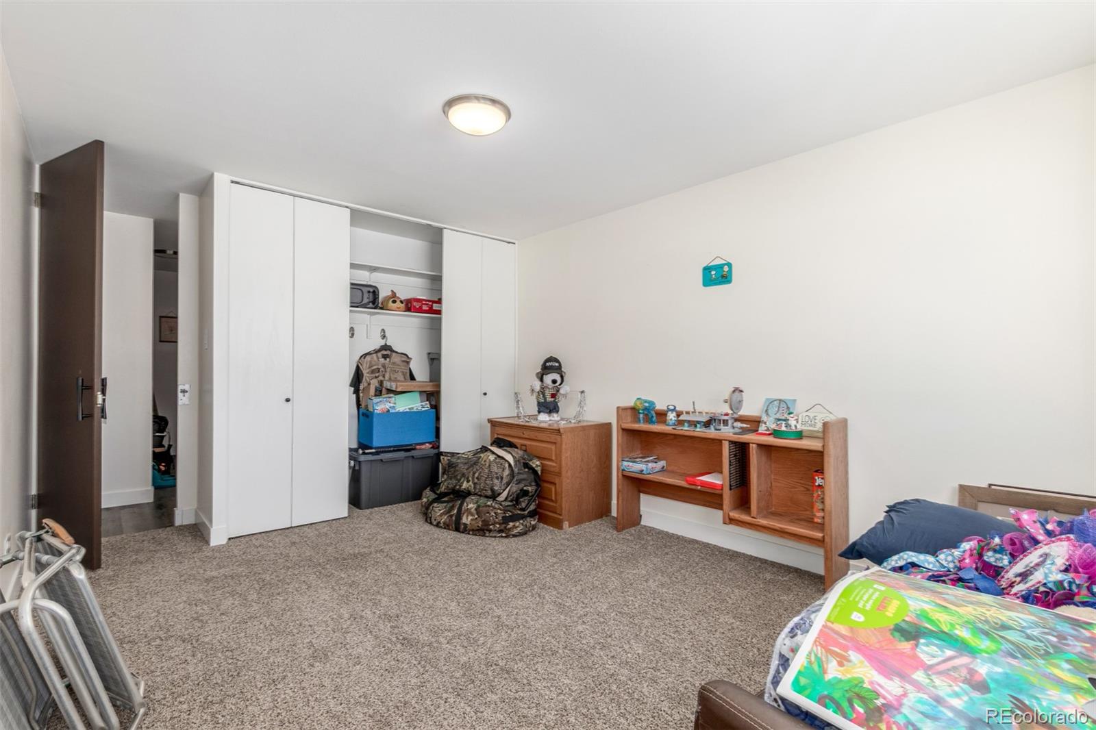 725 South Clinton Street, Unit 7B Denver, CO 80247 - Photo 24 of 29 a bedroom with bed and a window