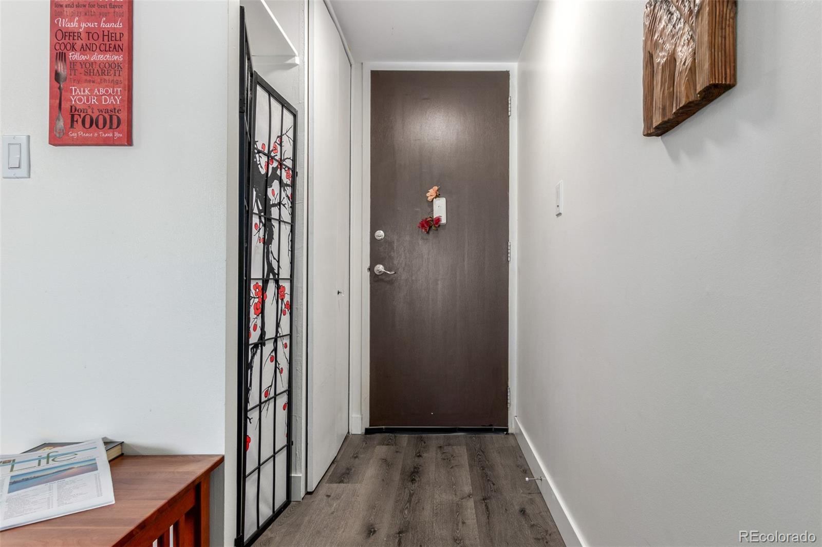 725 South Clinton Street, Unit 7B Denver, CO 80247 - Photo 4 of 29 a view of a hallway with wooden floor and a bathroom