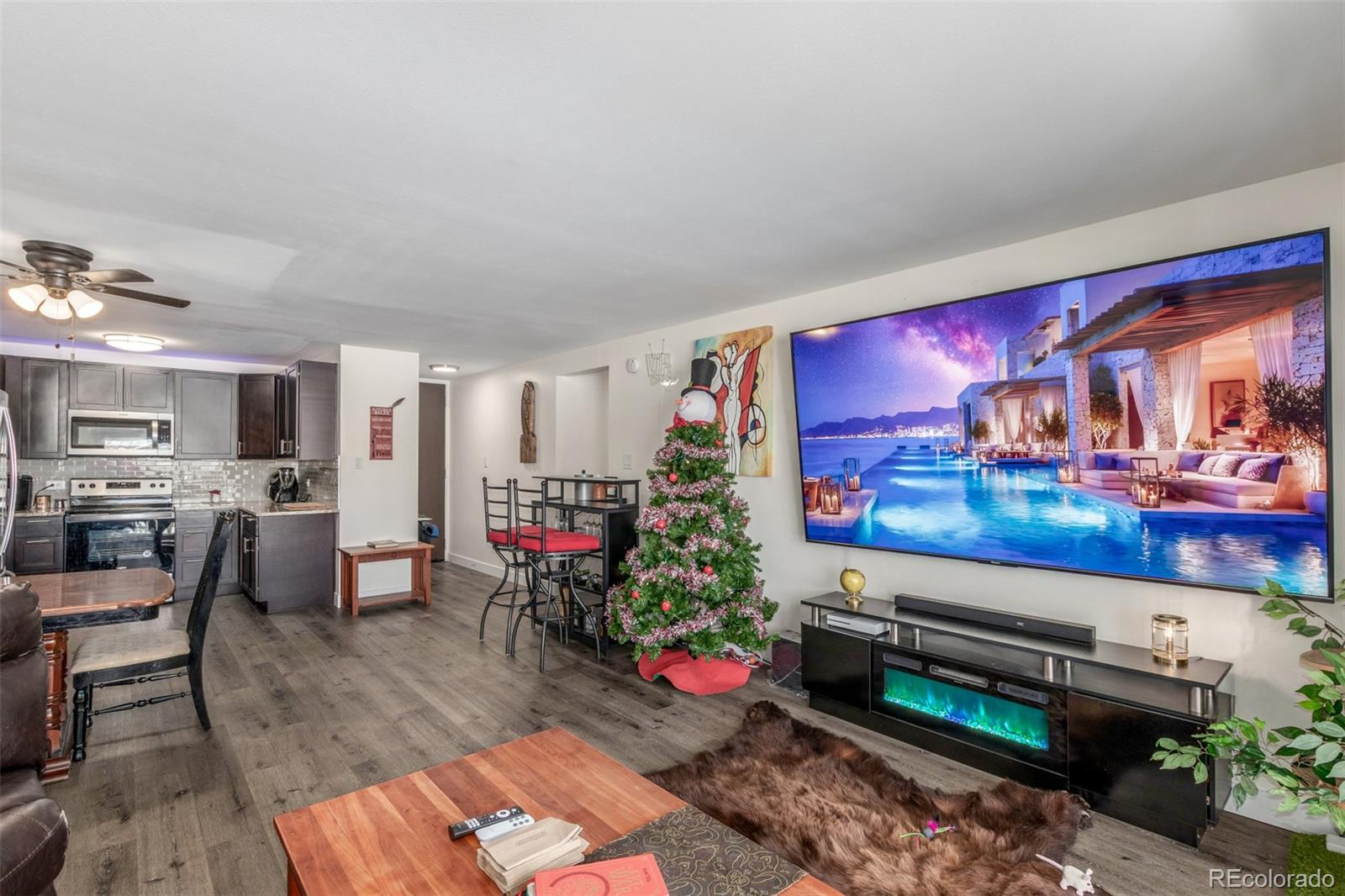 725 South Clinton Street, Unit 7B Denver, CO 80247 - Photo 6 of 29 a living room with furniture and a flat screen tv
