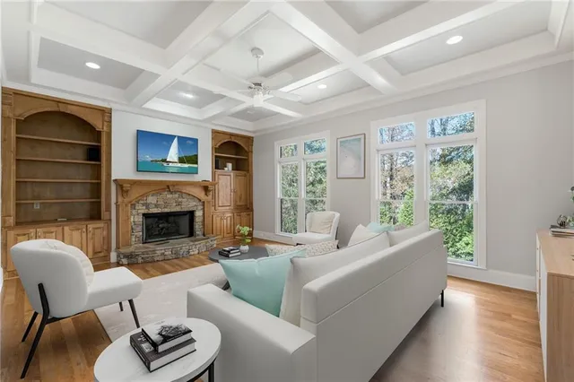 a living room with furniture a fireplace and a large window