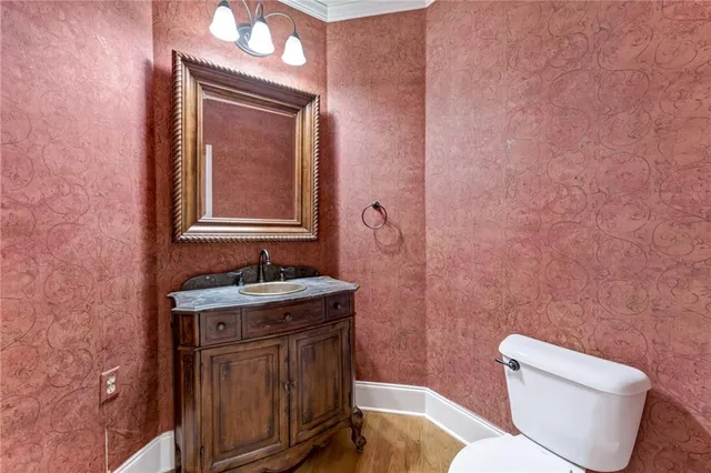 a bathroom with a toilet a sink and mirror