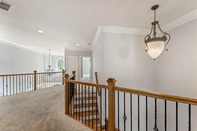 a bedroom with a large bed and ceiling fan