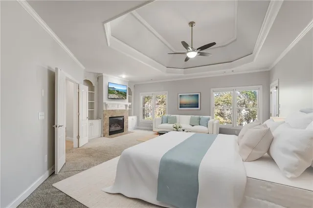 a view of a livingroom with a chandelier fan and windows