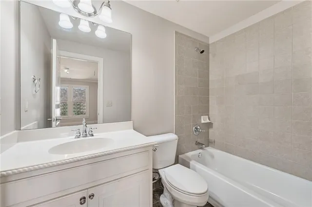 a view of a kitchen with white cabinets
