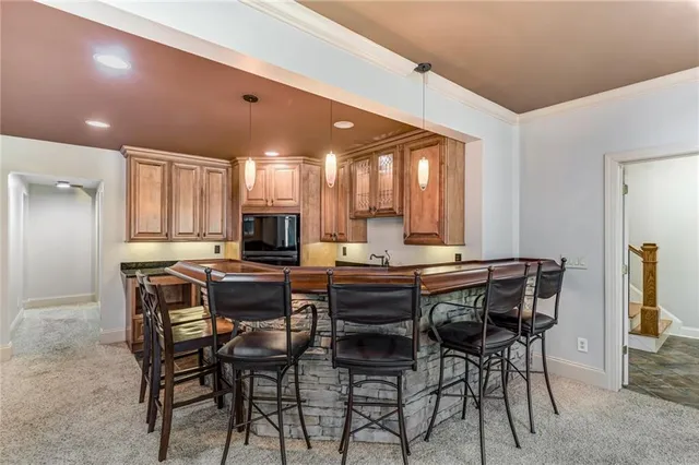 an empty room with wooden floor and entrance to ceiling room