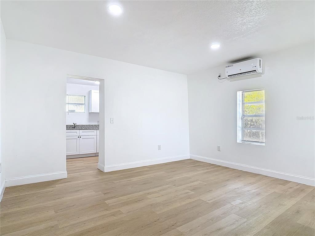 2410 SW Road Sanford, FL 32771 - Photo 11 of 30 an empty room with a window and wooden floor