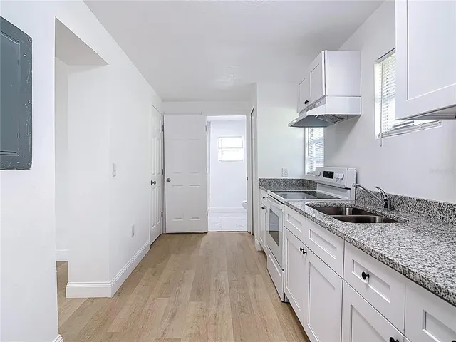 a kitchen with a sink and cabinets