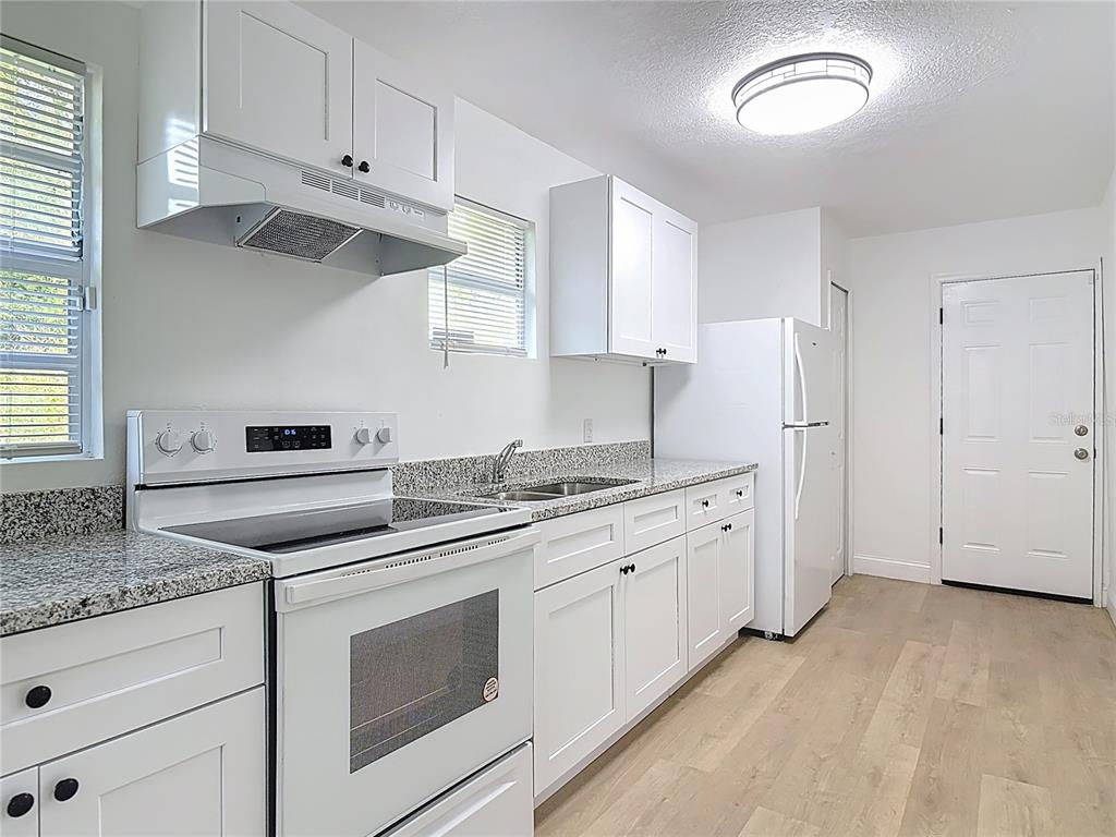2410 SW Road Sanford, FL 32771 - Photo 14 of 30 a kitchen with granite countertop cabinets stainless steel appliances and a counter space