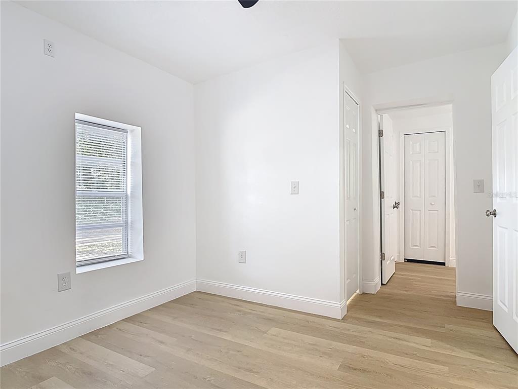2410 SW Road Sanford, FL 32771 - Photo 16 of 30 an empty room with wooden floor and windows