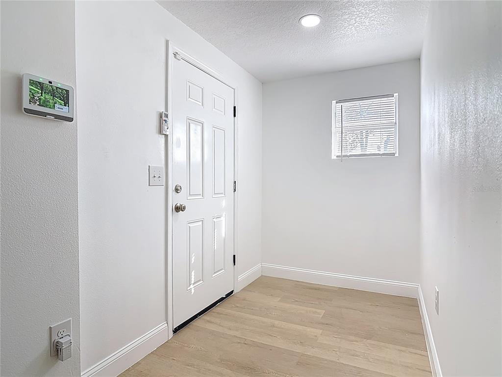 2410 SW Road Sanford, FL 32771 - Photo 5 of 30 an empty room with wooden floor and windows