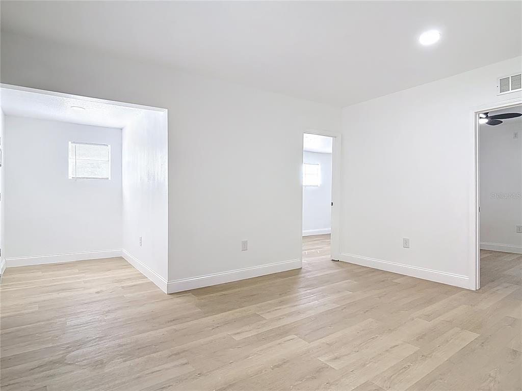 2410 SW Road Sanford, FL 32771 - Photo 7 of 30 an empty room with wooden floor and windows