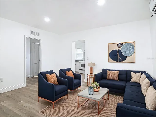 a living room with furniture and wooden floor
