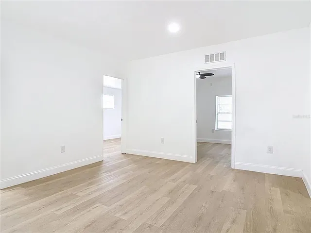 an empty room with wooden floor