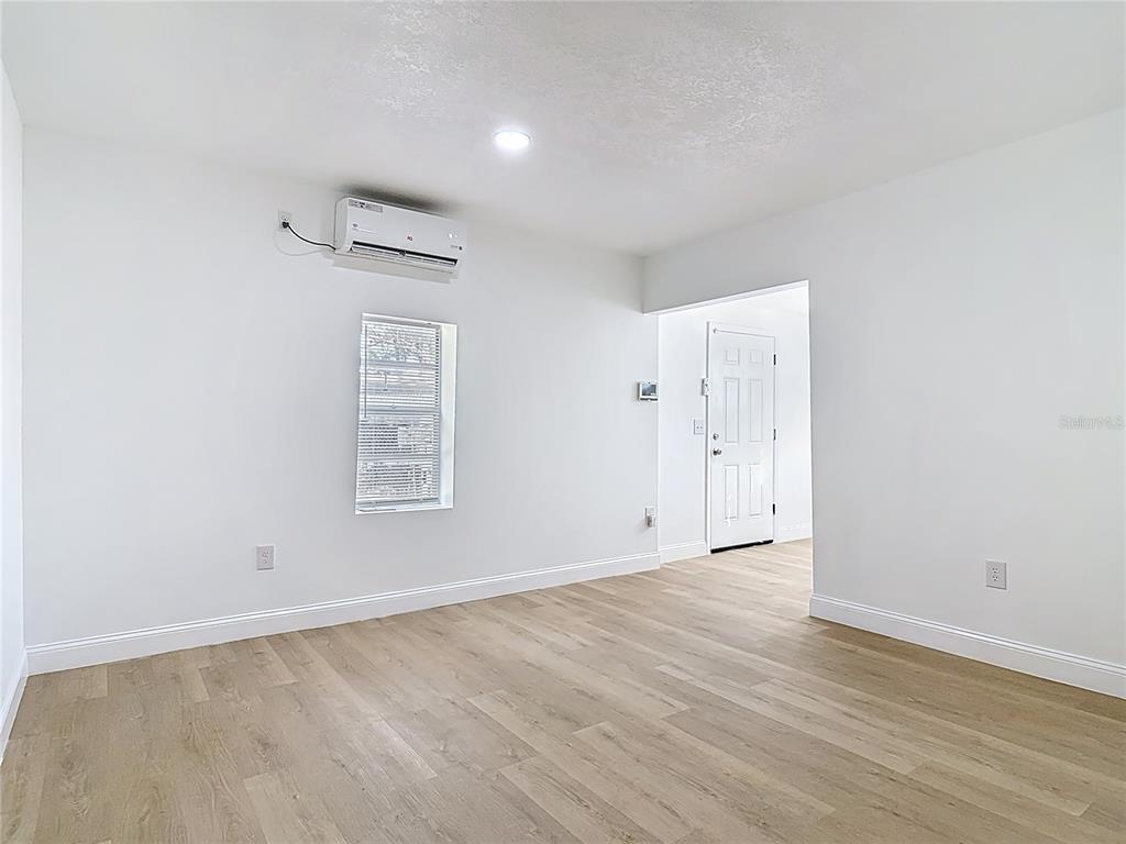 2410 SW Road Sanford, FL 32771 - Photo 10 of 30 a view of an empty room with wooden floor and a window