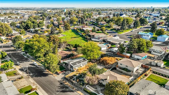 an aerial view of residential houses with outdoor space