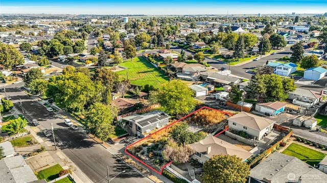an aerial view of residential houses with outdoor space