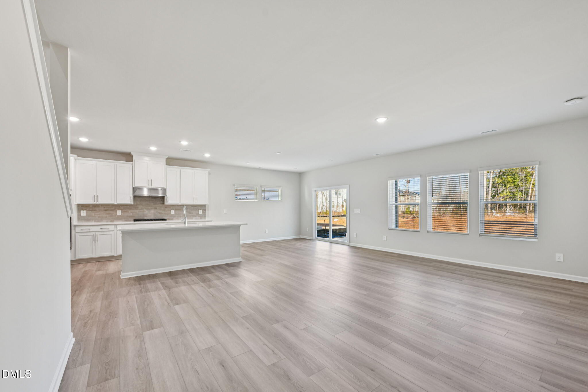 2145 Topsail Road Durham, NC 27703 - Photo 10 of 49 a view of an empty room with window and wooden floor