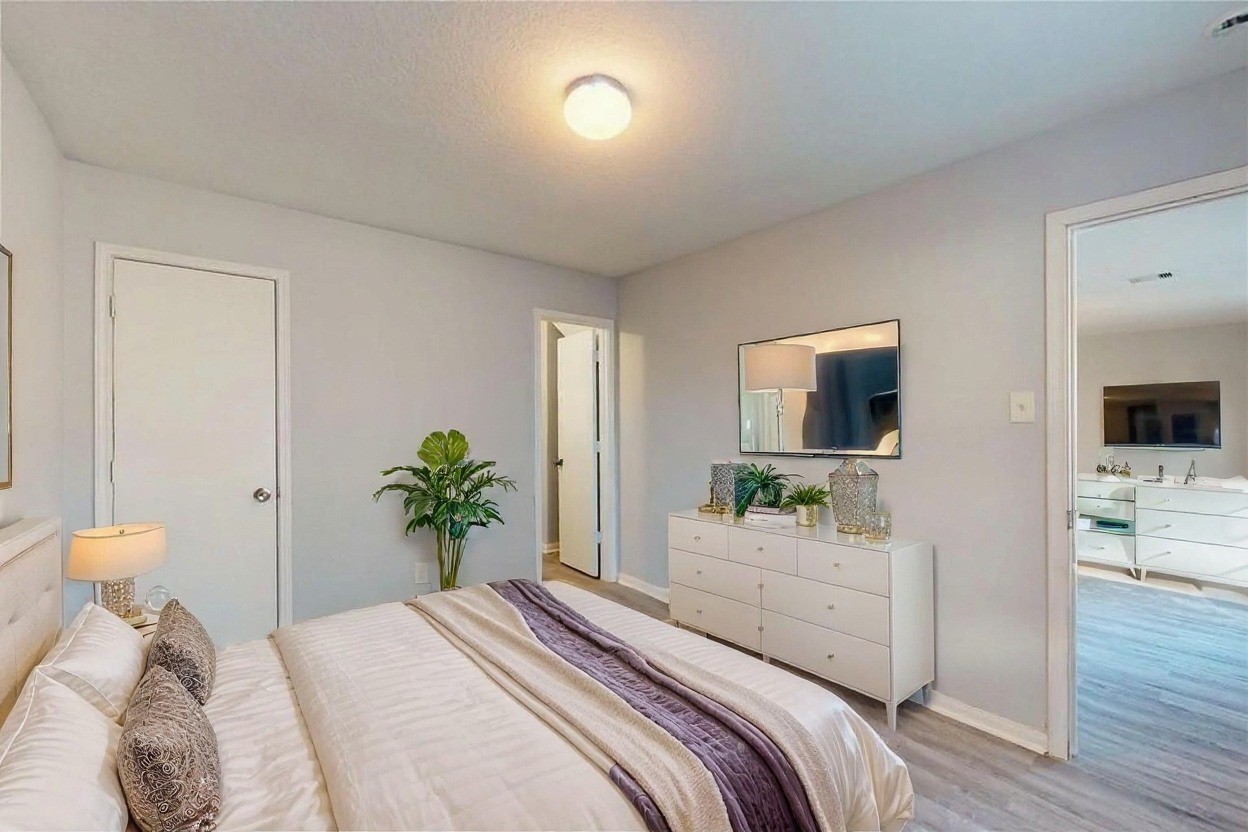 9877 Lace Flower Way Conroe, TX 77385 - Photo 30 of 43 a bedroom with a bed and a potted plant