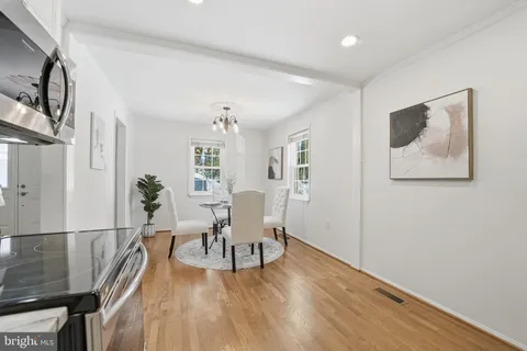 a view of a livingroom with furniture wooden floor and front door