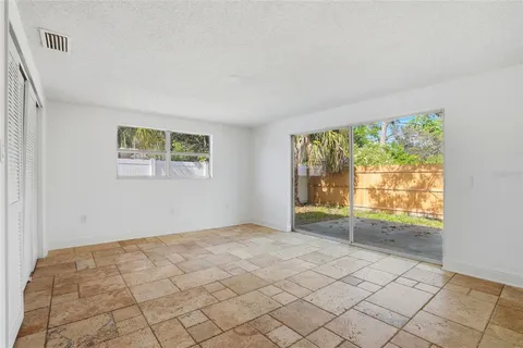 a view of a livingroom with wooden floor and a ceiling fan