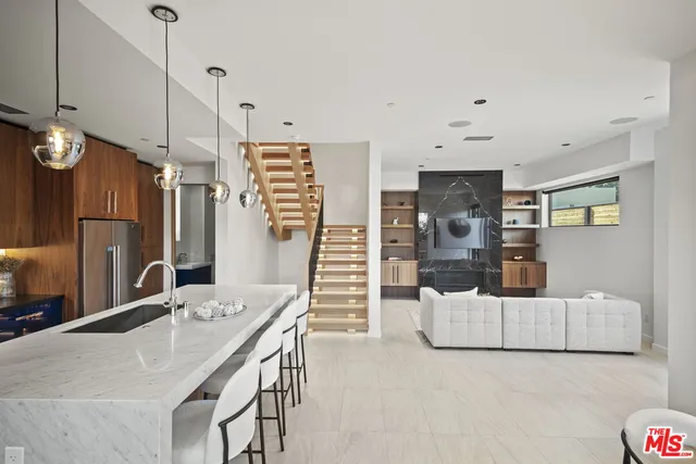 a view of kitchen with sink and refrigerator