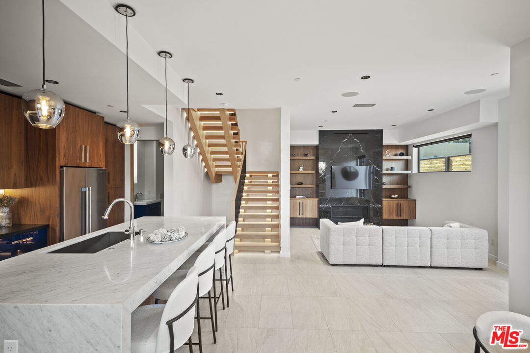 a view of kitchen with sink and refrigerator
