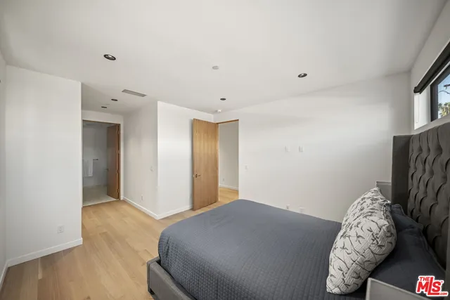 a bedroom with bed and window