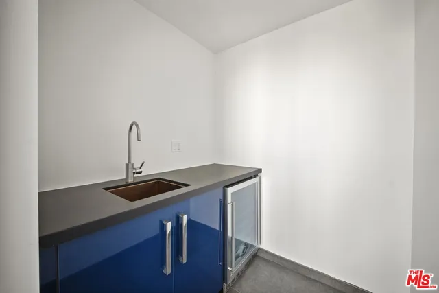 a kitchen with a table chairs refrigerator and cabinets