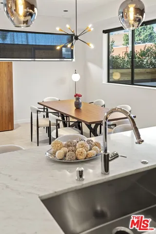 a room with water heater and wooden cabinets