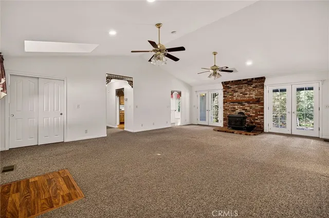 a view of an empty room with a fireplace
