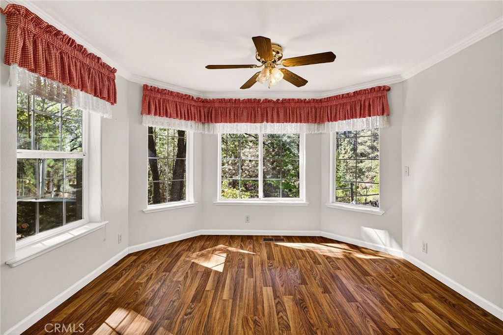 10202 Cohasset Road Chico, CA 95973 - Photo 23 of 71 a view of an empty room with wooden floor and a window