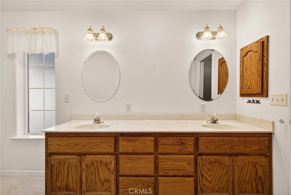 10202 Cohasset Road Chico, CA 95973 - Photo 28 of 71 a bathroom with a double vanity sink and a mirror