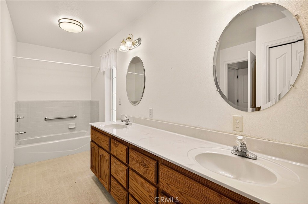 10202 Cohasset Road Chico, CA 95973 - Photo 29 of 71 a bathroom with a double vanity sink mirror and bathtub