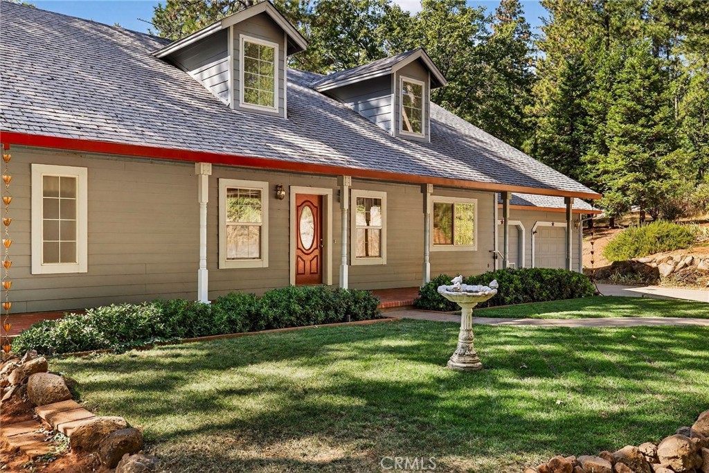 10202 Cohasset Road Chico, CA 95973 - Photo 6 of 71 a front view of a house with garden and trees