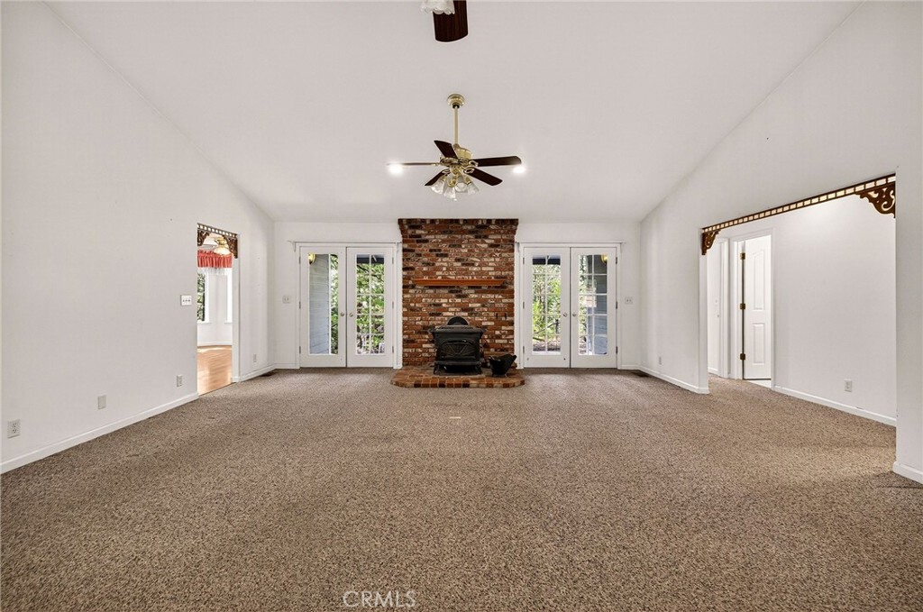 10202 Cohasset Road Chico, CA 95973 - Photo 10 of 71 an empty room with windows chandelier fan and windows