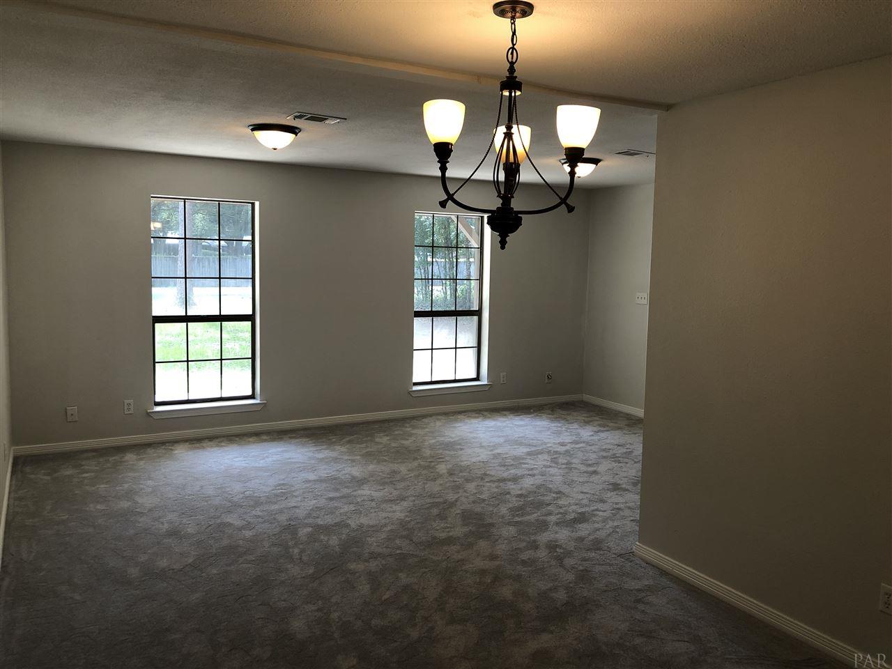 5577 Northrop Road Milton, FL 32570 - Photo 7 of 18 Living dining combo with new carpet and lighting