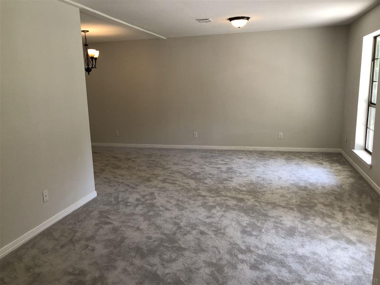 5577 Northrop Road Milton, FL 32570 - Photo 8 of 18 Living Dining Combo with new carpet and lighting