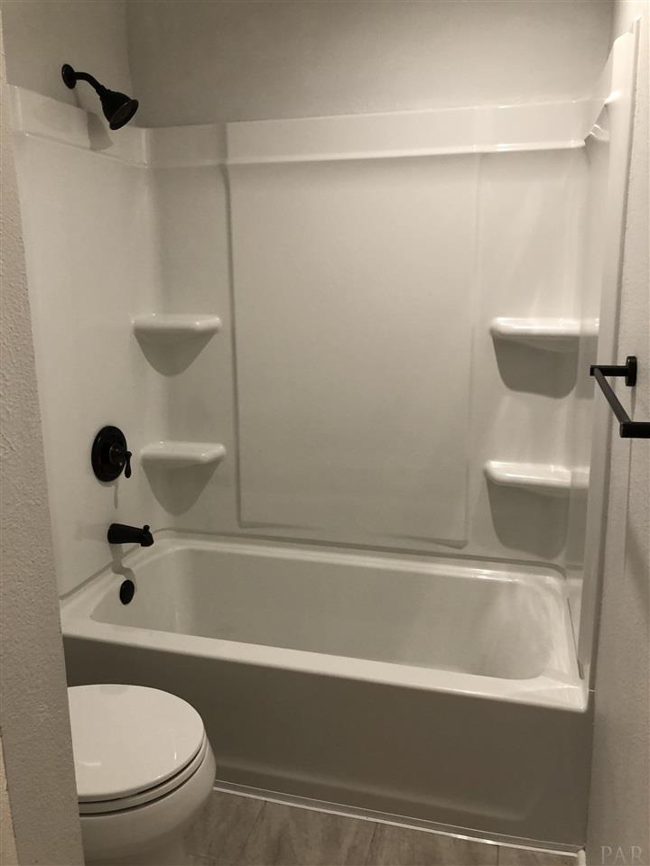 5577 Northrop Road Milton, FL 32570 - Photo 10 of 18 New shower tub combo, toilet and tile floors