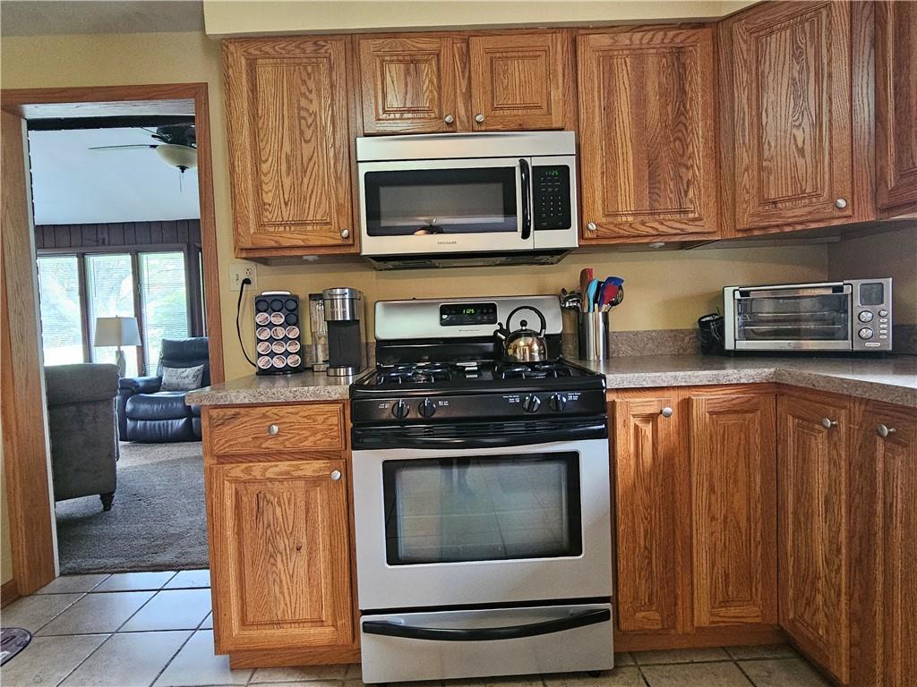 1018 Chicora Road Chicora, PA 16025 - Photo 16 of 43 a kitchen with stainless steel appliances granite countertop a stove microwave and cabinets