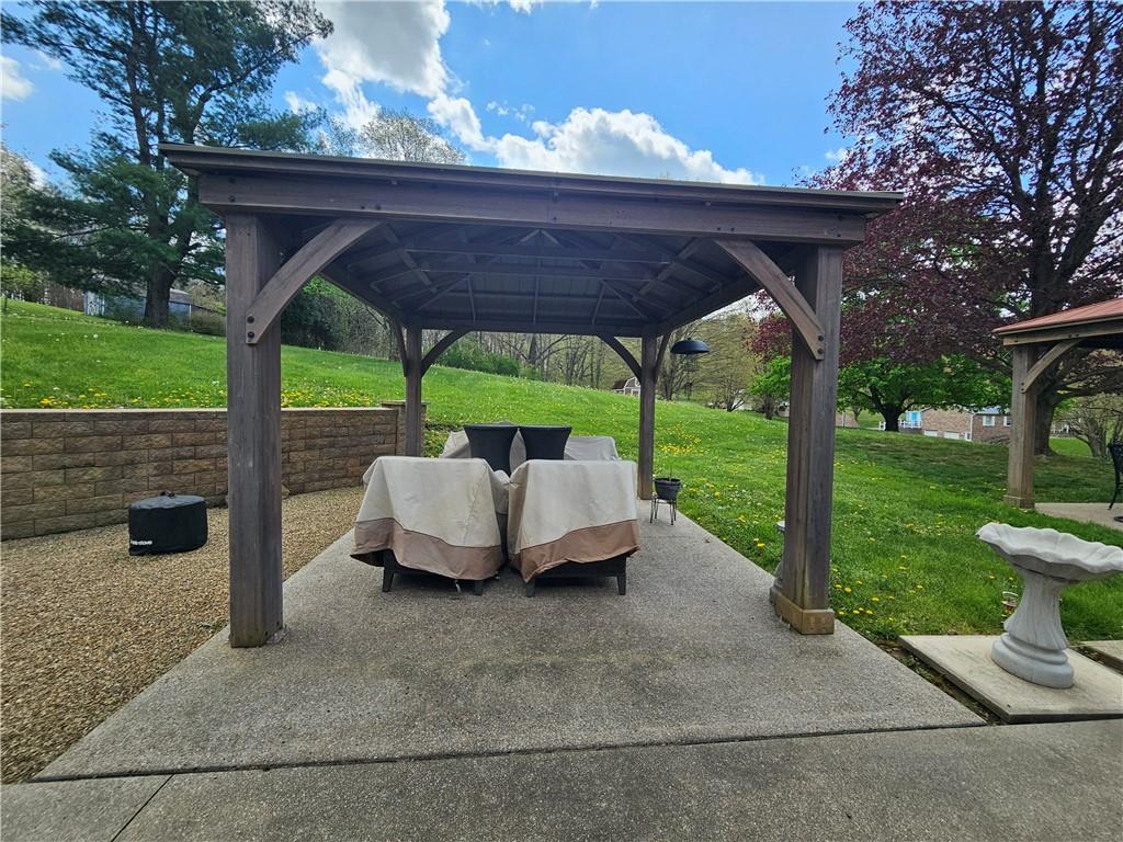 1018 Chicora Road Chicora, PA 16025 - Photo 27 of 43 a view of a patio with table and chairs under an umbrella