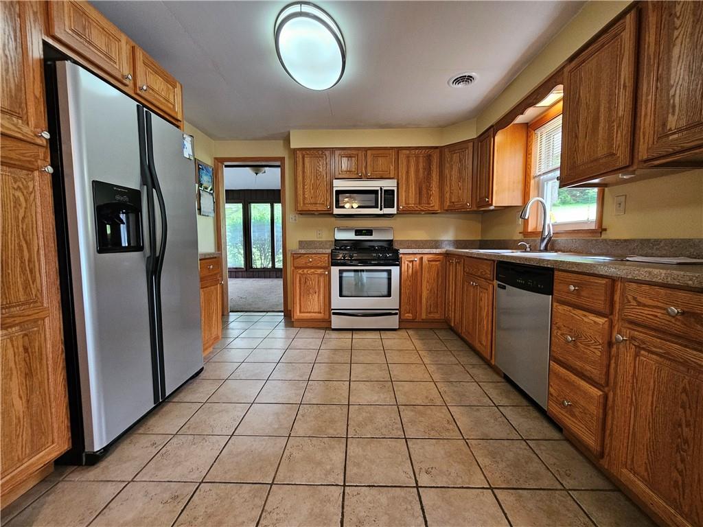 1018 Chicora Road Chicora, PA 16025 - Photo 4 of 43 a kitchen with stainless steel appliances granite countertop a stove top oven a sink dishwasher a refrigerator and cabinets
